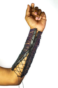 Our Maasai Bead Gauntlets are handcrafted in Kenya by our local artisan using hand-strung glass Maasai beads and genuine leather byproduct sourced from local farms. It is currently available in gunmetal, red or white beading with custom colored beading available. All odAOMO accessories are designed by Dr. Sophia Omoro.