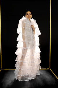 Our Floor Length Ruffle Cape is handmade in Ghana using fine nylon tulle and 100% cotton trim. The Elizabethan inspired collar creates a perfect frame for the face and the design of the body creates dramatic volume. The sheerness of the tulle keeps it light and airy. All odAOMO garments are designed by Dr. Sophia Omoro.